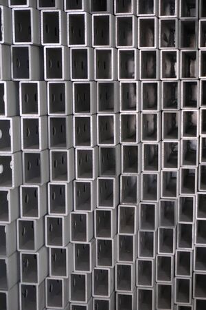 close up stack of square aluminum tube in factory