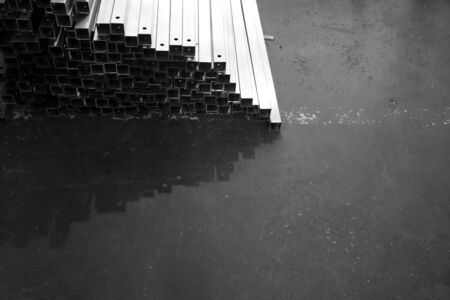 grop of metal stock with different size in warehouseの写真素材