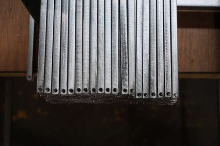 grop of metal stock with different size in warehouseの写真素材