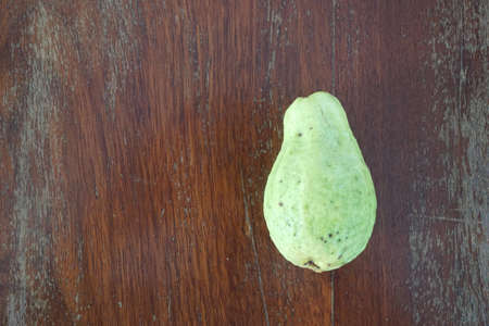 close up wild guava fruit on the wood board backgroundの写真素材
