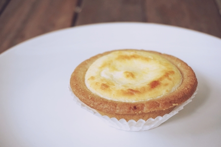 bake cheese tart on the wooden backgroundの写真素材