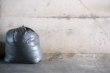 black plastic garbage with the old concrete backgroundの写真素材