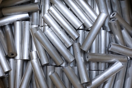 close up stack of round aluminum  tube in factoryの写真素材