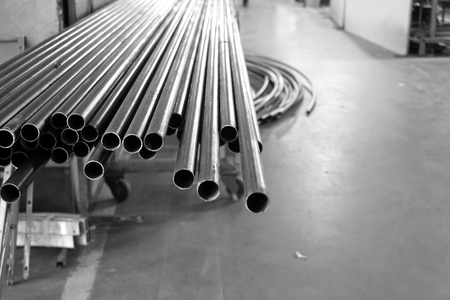 close up stack of round iron tube in factoryの写真素材