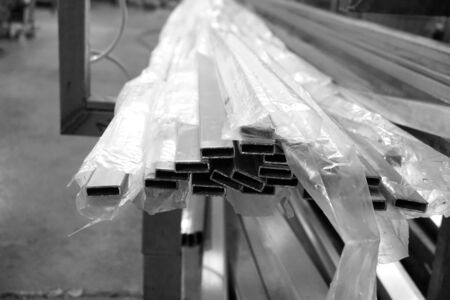 stack of aluminum square tube in the factoryの写真素材