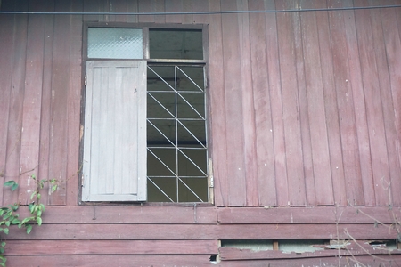 close up broken window in abandoned houseの写真素材