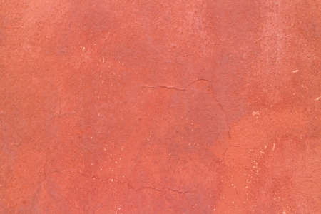 Crack red painted wall texture background.の写真素材