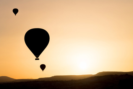 Silhouette of hot air balloons fly over Cappadocia.の写真素材