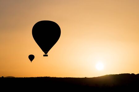 Silhouette of hot air balloons fly over Cappadocia.の写真素材