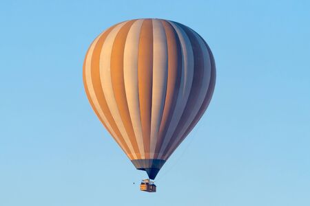 A hot air balloon flying on a clear sky day.の写真素材