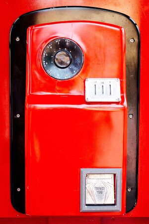Vintage red telephone on white background.