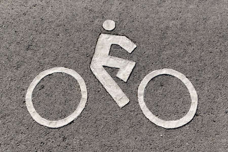 Bicycle lane signage on asphalt street.の写真素材
