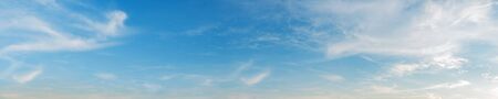 Vibrant color panoramic sky with cloud on a sunny day. Beautiful cirrus cloud. Panorama high resolution photograph.の写真素材