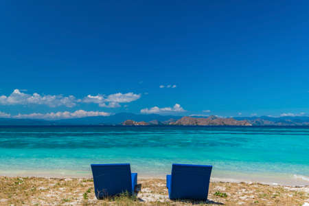 Beautiful beach. Sunbeds with umbrella on the sandy beach near the sea. Summer holiday and vacation concept. Inspirational tropical beach.の写真素材