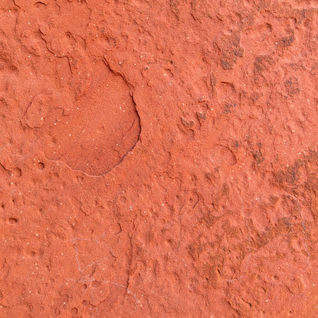 Red rough stone texture background. Material construction and architectural detail.の写真素材
