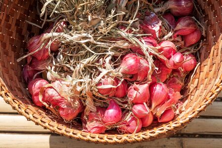Organic shallot background vegetables in the wooden tray.