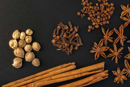 Assorted colorful spices on a black background. Healthy diet lifestyle.の写真素材