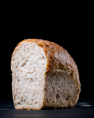 Fresh whole wheat bread with a coffee mug on black background. Healthy eating breakfast.の写真素材