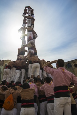 REUS, SPAIN - OCTOBER 10, 2014: Castells Performance, a castell is a human tower built traditionally in festivals within Catalonia. This is also inscribed on the UNESCO Representative List of the Intangible Cultural Heritage of Humanityのeditorial素材