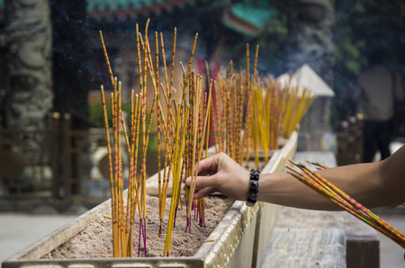 Yellow incense sticks burning at a Taoist temple of Wong Tai Sin, Hong Kong.のeditorial素材
