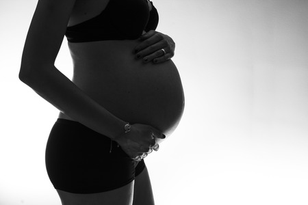 Motherhood: pregnant woman belly silhouette in Black and white