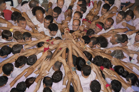 REUS, SPAIN - OCTOBER 3, 2009: Castells Performance, a castell is a human tower built traditionally in festivals within Catalonia. This is alsoon the UNESCO Intangible Cultural Heritage of Humanityのeditorial素材