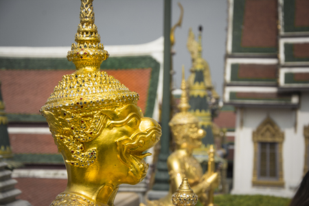 Golden statue in the Temple of the Emerald Buddha Wat Phra Kaew, Bangkok, Thailandの写真素材