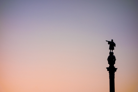 Christopher Columbus statue is one of the iconic images of Barcelona. In this case, sunset silhouette view against a clear sky.の写真素材