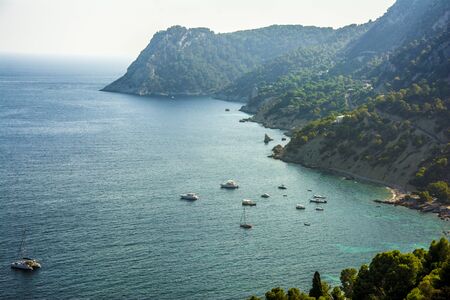 Summer time. Sailboats in the mediterranean turquoise waters of Ibiza islandの写真素材