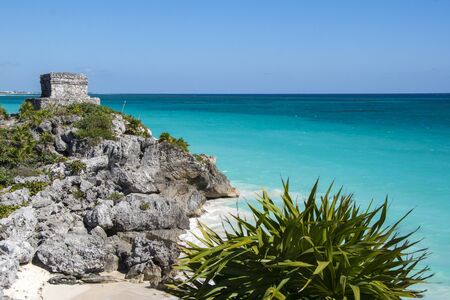 Beautiful beach with turquoise water  in Tulum Mexico, Mayan ruins on top of the cliff.の写真素材