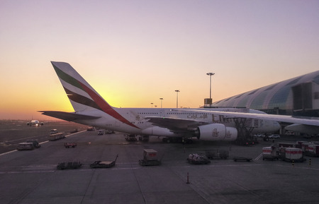Dubai, UAE, December 2013: Airbus docked in Dubai airport ar sunrise time.のeditorial素材