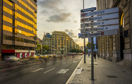 A street sign located in Carrer Arago in Barcelona, Spain, with directions of the main streets of the city, like Plaza Catalunya, Plaza Espana, Passeig de Gracia and Plaza Lesseps..の写真素材