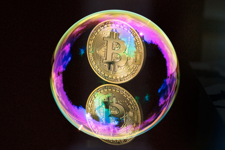 bitcoin and a soap bubble on black backgroundの写真素材