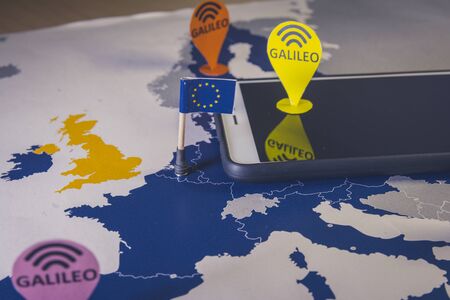 Toy car, Galileo pin and a smartphone Over a EU map. Galileo system metaphor