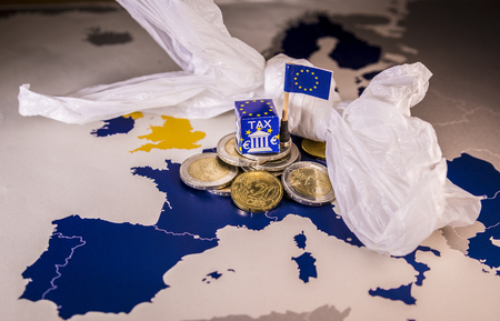 EU map with euro coins and a plastic bag symbolizing european plastic tax regulation.The European Union plans to propose a tax on plastic bags and packaging in the interest of the world's oceansの写真素材