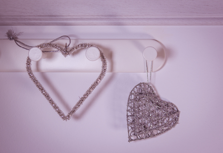 Heart shape hangers on red background. Valentines day concept.の写真素材