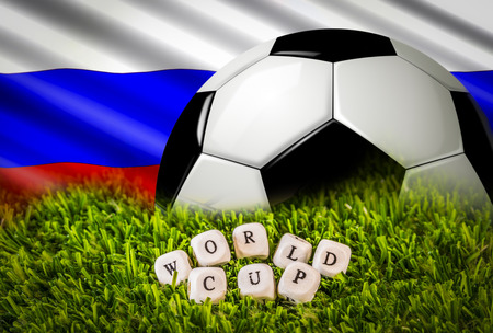 Russian flag, Football ball phrase formed by wooden letters over green grass.の写真素材