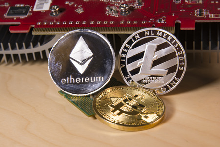 Financial concept with physical bitcoin, ethereum and Litecoin with a Video card.の写真素材