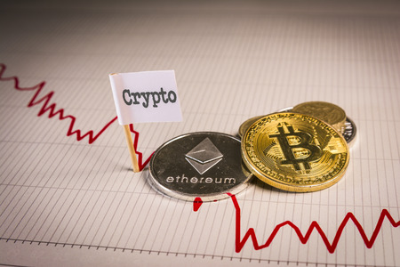Financial bear market falling concept with bitcoin and ethereum on chart background.の写真素材