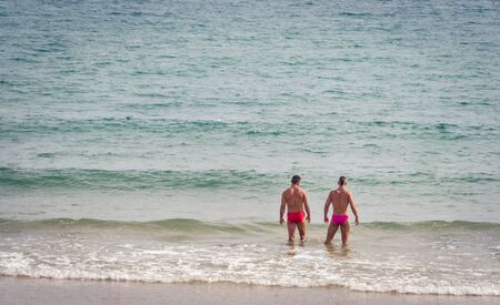 Sitges, Spain, September 2018. Gay couple on vacation at the beachのeditorial素材