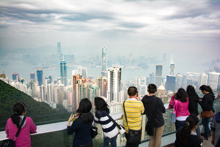 Chinese anonymous people looking at Hong Kong skyline from Victorias peakの写真素材