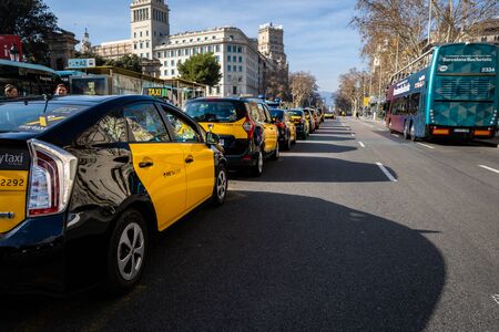 Barcelona, Spain, February 2019: Barcelona typical yellow and black taxis in a rowのeditorial素材