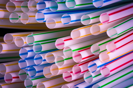 Background of colourful plastic straws as an environmental problem.