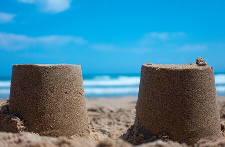Closeup of sandcastles on the sand of a beachの写真素材