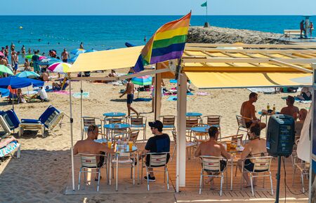 Sitges, Spain, September 2018. Gay couple on vacation at the beach