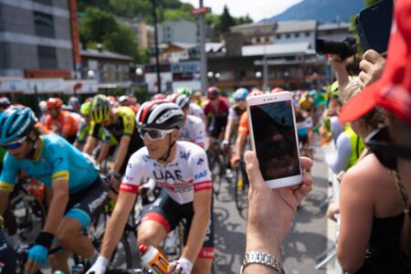 Andorra la Vella, Andorra. September 2019: Cycling fan taking a picture with the smartphone of Cyclists of the Vuelta de Espanaのeditorial素材