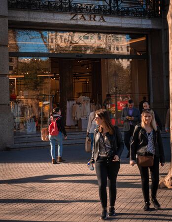 Barcelona, Spain. March 19: People in front of Zara shop in Barcelonas downtown, Plaza Catalunya, considered the city center. Consumerism concept.のeditorial素材