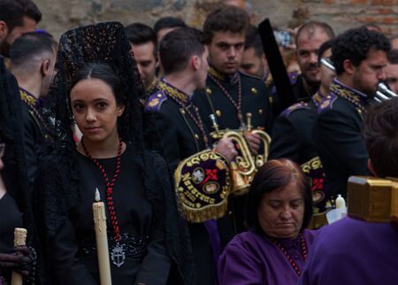 Girl in Easter procession with a black lace mantilla, a traditional Spanish veil worn by the womenのeditorial素材