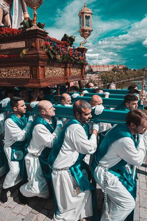 Merida, Spain. April 2019: A group of bearers, called Costaleros, carrying a religious floatのeditorial素材