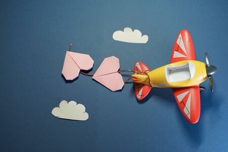 Airplane toy with origami paper pink hearts.の写真素材